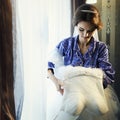 Bride adjust a wedding dress in the front of the window