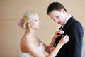 Bride adjusting groom's boutonniere Royalty Free Stock Photo