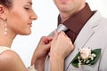 Bride adjusting groom's tie