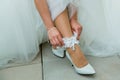 The bride adjusts the garter on her leg Royalty Free Stock Photo