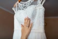 The bride adores wedding dress, white lace, bride`s hand with lace and manicure, morning bride Royalty Free Stock Photo