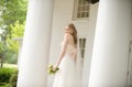 Bride against a columned porch