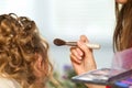 Bride applying wedding make-up