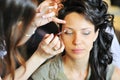Bride applying wedding make-up by make-up artist Royalty Free Stock Photo
