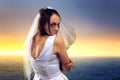 Bride on the background of the sea and sunset
