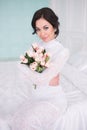 A bride in a beautiful dress holding a bouquet of flowers . Wedding. Bride`s morning. Fine art Royalty Free Stock Photo