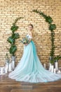 Bride in a beautiful turquoise dress in anticipation of wedding. Blonde in lace dress sea green with a bouquet . Happy bride Royalty Free Stock Photo