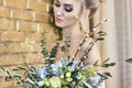 Bride in a beautiful turquoise dress in anticipation of wedding. Blonde in lace dress sea green with a bouquet . Happy bride Royalty Free Stock Photo