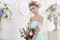 Bride in a beautiful turquoise dress in anticipation of wedding. Blonde in lace dress sea green with a bouquet . Happy bride Royalty Free Stock Photo