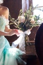 Bride in a beautiful turquoise dress in anticipation of wedding. Blonde in lace dress sea green with a bouquet . Happy bride Royalty Free Stock Photo