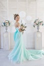 Bride in a beautiful turquoise dress in anticipation of wedding. Blonde in lace dress sea green with a bouquet . Happy bride Royalty Free Stock Photo