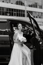 bride with a black car Royalty Free Stock Photo