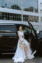 bride with a black car Royalty Free Stock Photo