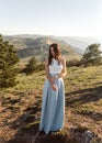 Bride in blue dress in the beautiful landscape in sunlight Royalty Free Stock Photo