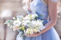 A bride in a blue wedding dress holds a wedding bouquet in her hands Royalty Free Stock Photo