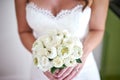 The bride with bouquet made with white cream lotus and roses flower, focus on the bouquet - closed up Royalty Free Stock Photo