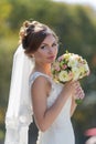 Bride with bouquet in park Royalty Free Stock Photo