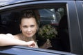 Bride with bouquet sitting in wedding car Royalty Free Stock Photo