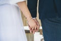 Bride and bridegroom holding hands with a bracelet Royalty Free Stock Photo