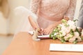 Bride and bridegroom signing the marriage contract after the wedding ceremony Royalty Free Stock Photo