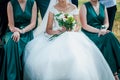 Bride and bridesmaid holding bouquet of flowers in the hand Royalty Free Stock Photo