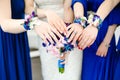 Bride and bridesmaids in blue dress reach out their hands with tender wedding bouquets Royalty Free Stock Photo