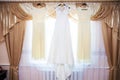 Bride and bridesmaids dresses hanging on hangers