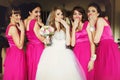 Bride and bridesmaids flirt standing in the restaurant