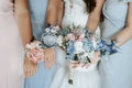 Bride and bridesmaids hand with beautiful flowers. Bridesmaids have control over bouquets Royalty Free Stock Photo