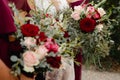 Bride with bridesmaids in magenta burgundy dresses with wedding florals - deep red and white roses with seeded eucalyptus leaves