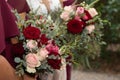 Bride with bridesmaids in magenta burgundy dresses with wedding florals - deep red and white roses with seeded eucalyptus leaves