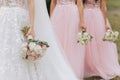 Bride With Bridesmaids Outdoors At Wedding. Row of bridesmaids with bouquets at wedding ceremony. Royalty Free Stock Photo