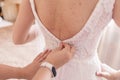 Bride buttoning her wedding dress in the morning Royalty Free Stock Photo