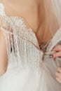 the bride buttoning a white dress. Morning of the bride Royalty Free Stock Photo