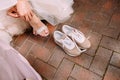 Bride changes shoes sports sneakers walking paving