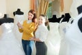 Bride chooses bridal outfit at wedding store Royalty Free Stock Photo