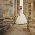 Bride between the columnes of the castle Royalty Free Stock Photo