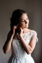 Bride corrects the earring, Beautiful earrings and hands of the bride Royalty Free Stock Photo