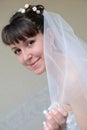 The bride covered with a veil looks afar Royalty Free Stock Photo