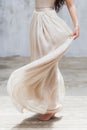 Bride dancing in a long gentle silk dress fine art trendy style. Pastel color