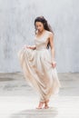 Bride dancing in a long gentle silk dress fine art trendy style. Pastel color