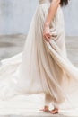 Bride dancing in a long gentle silk dress fine art trendy style. Pastel color