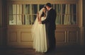 Bride daydreams while groom hugs her behind the mirror