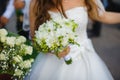 Bride in Dress Holds Bridal Bouquet with Freesia