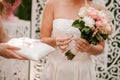 Bride dressed in a beautiful white wedding dress holding a ring Royalty Free Stock Photo