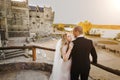 Bride embracing groom while standing near handrails