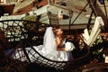 Bride enjoys summer sun standing on the spiral stairs on the roof