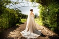 Bride in fashion wedding dress on natural background. A beautiful woman portrait in the park. Back view Royalty Free Stock Photo