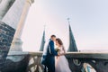 Bride and fiance have sensual moment on the balcony of antique gothic cathedral Royalty Free Stock Photo