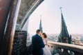 Bride and fiance have sensual moment on the balcony of old Gothic cathedral Royalty Free Stock Photo